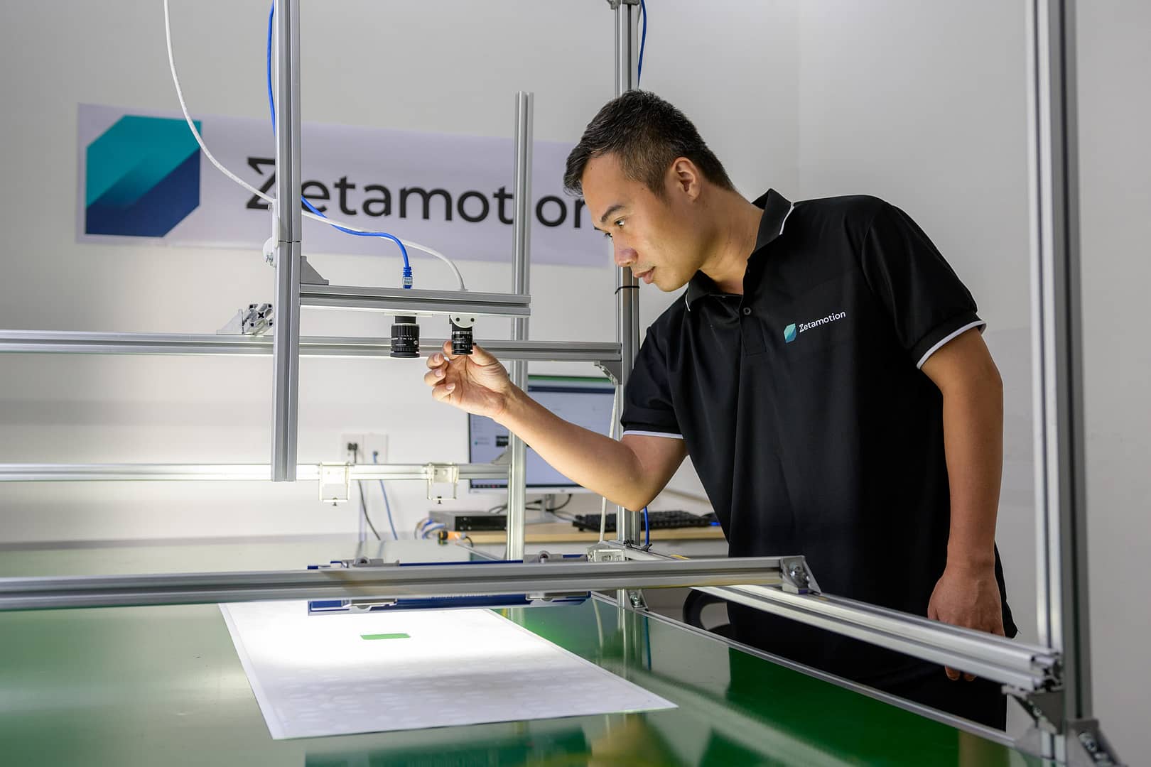 Zetamotion employee inspecting physical components of the Spectron QCaaS platform offered by Zetamotion on the production line