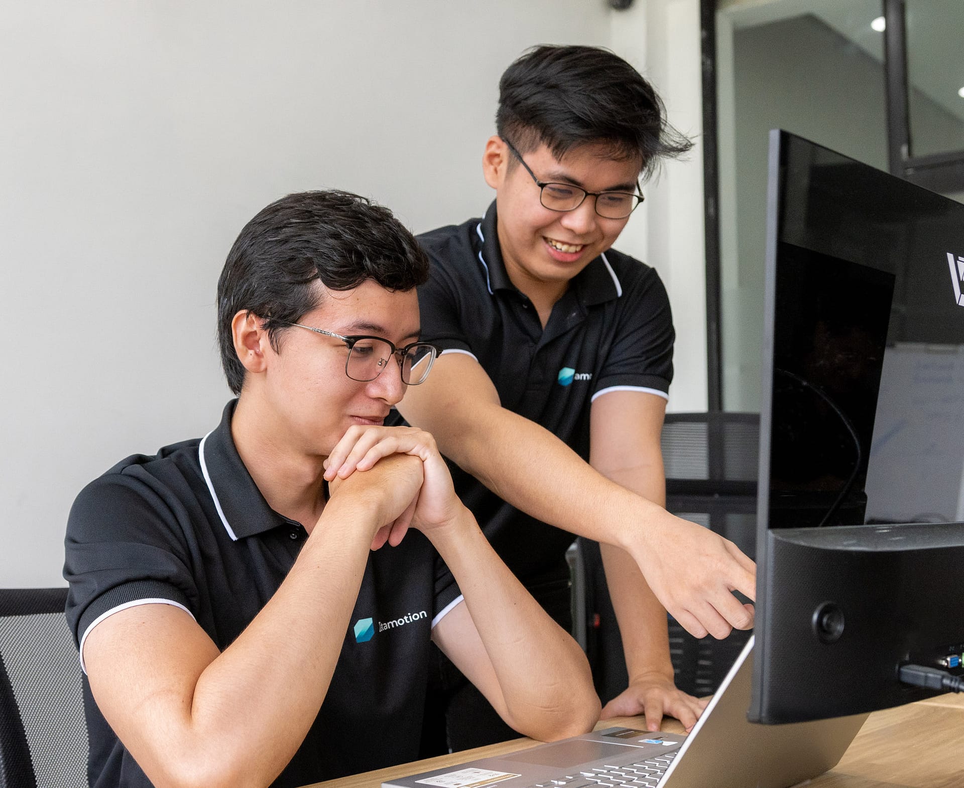 Zetamotion employees at work in the Vietnam Office, happily assisting customers